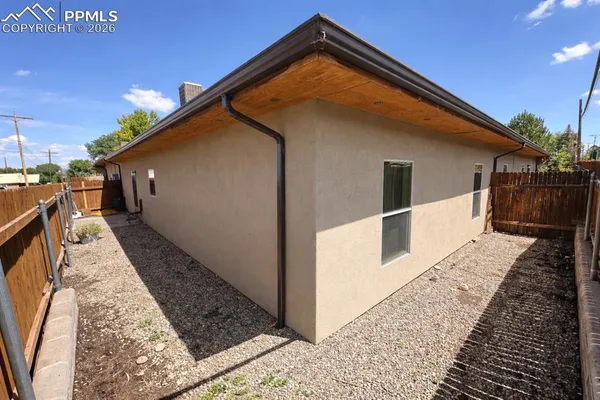 a view of house with wooden floor and a small yard