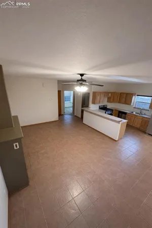 a view of a livingroom with furniture and white walls