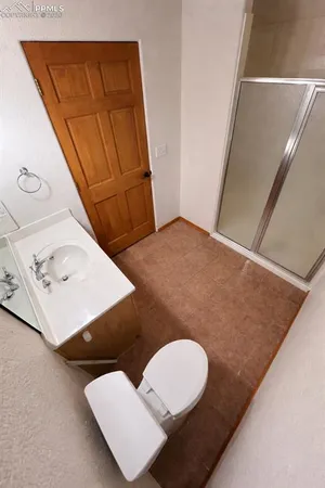 a bathroom with a sink toilet and mirror