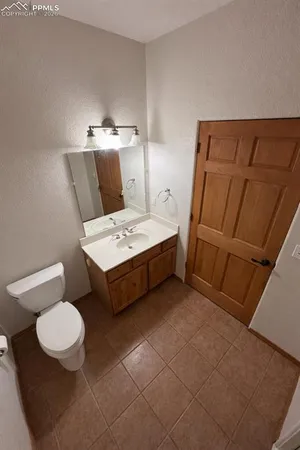 a bedroom with a bed and a mirror