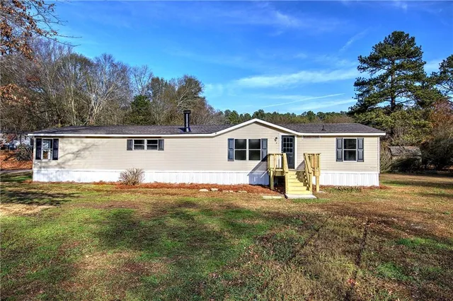 a view of a house with a backyard