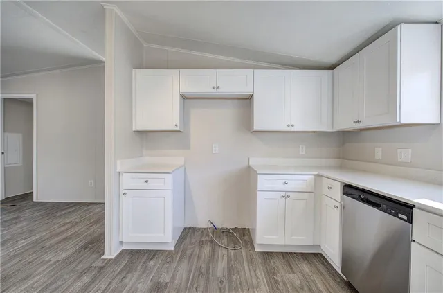 a kitchen with white cabinets and white appliances