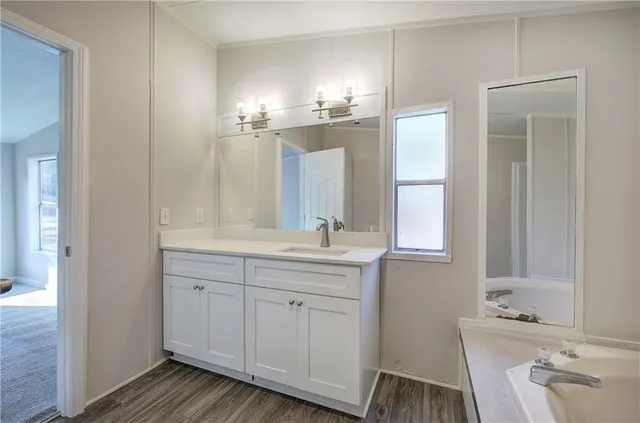 a bathroom with a double vanity sink and a mirror