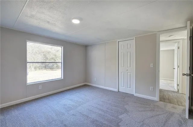 an empty room with a empty space and windows