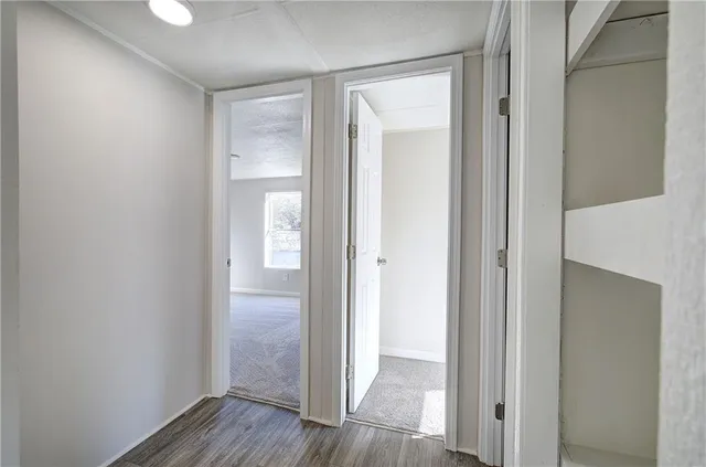 a view of a hallway with wooden floor