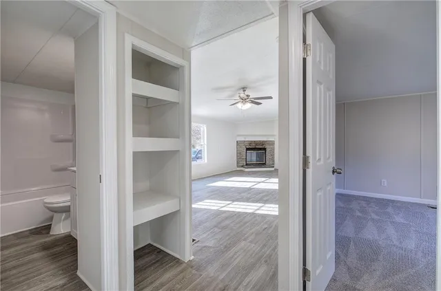 a view of bathroom from a hallway with toilet