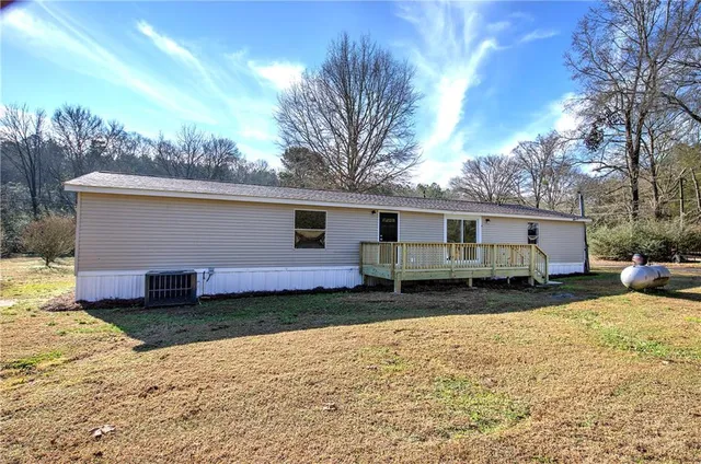 a view of a house with a yard covered in snow