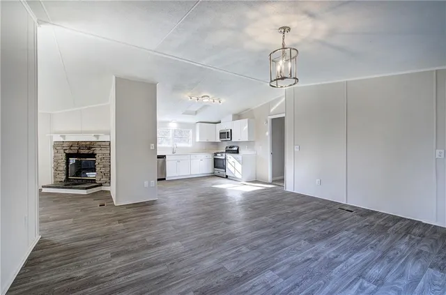 a view of a kitchen with wooden floor and a sink