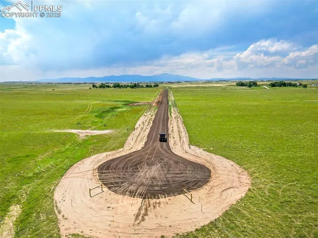 a view of a swimming pool with a yard