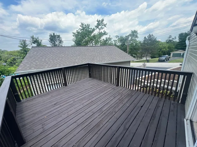 a terrace view with wooden floor and fence