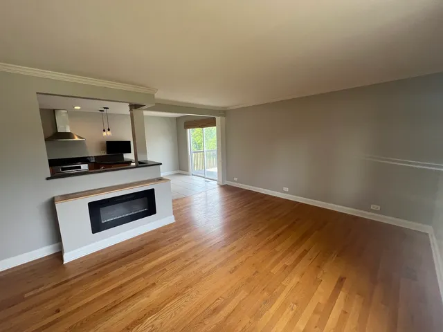 a kitchen with granite countertop wooden floors and stainless steel appliances
