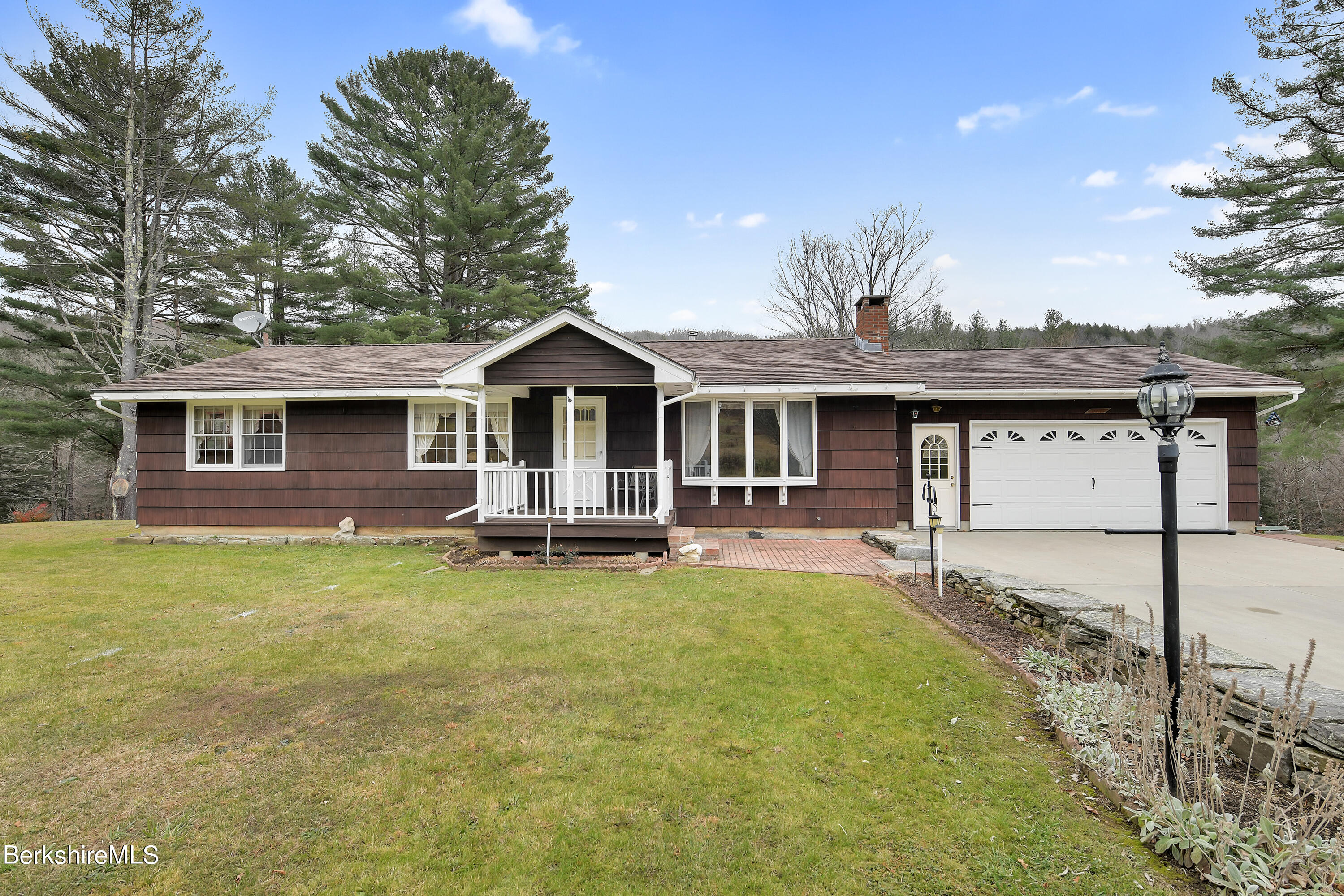 100 Town Hill Road Middlefield, MA 01011 - Photo 1 of 76 a front view of a house with a garden and patio