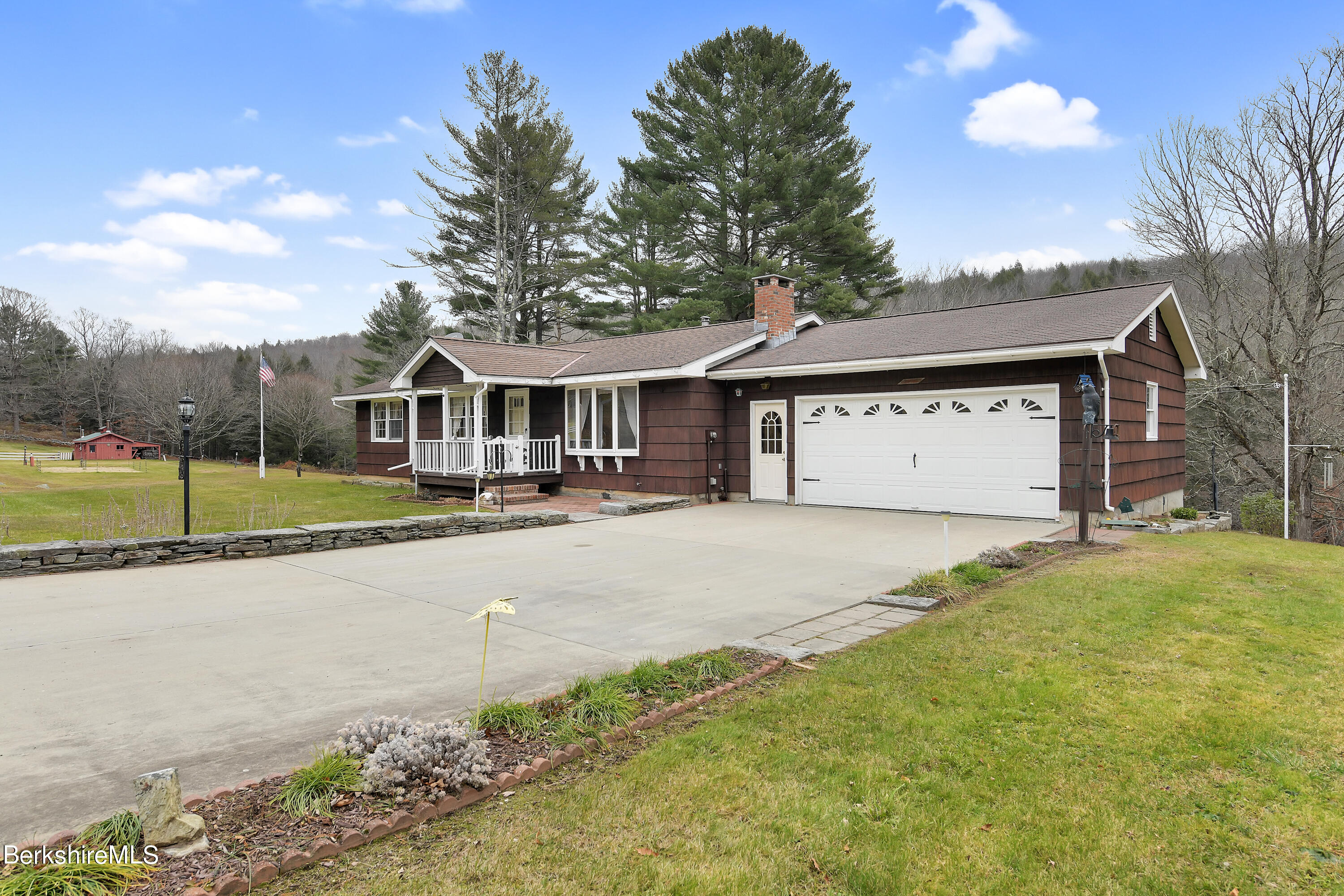 100 Town Hill Road Middlefield, MA 01011 - Photo 3 of 76 a front view of a house with a yard and garage