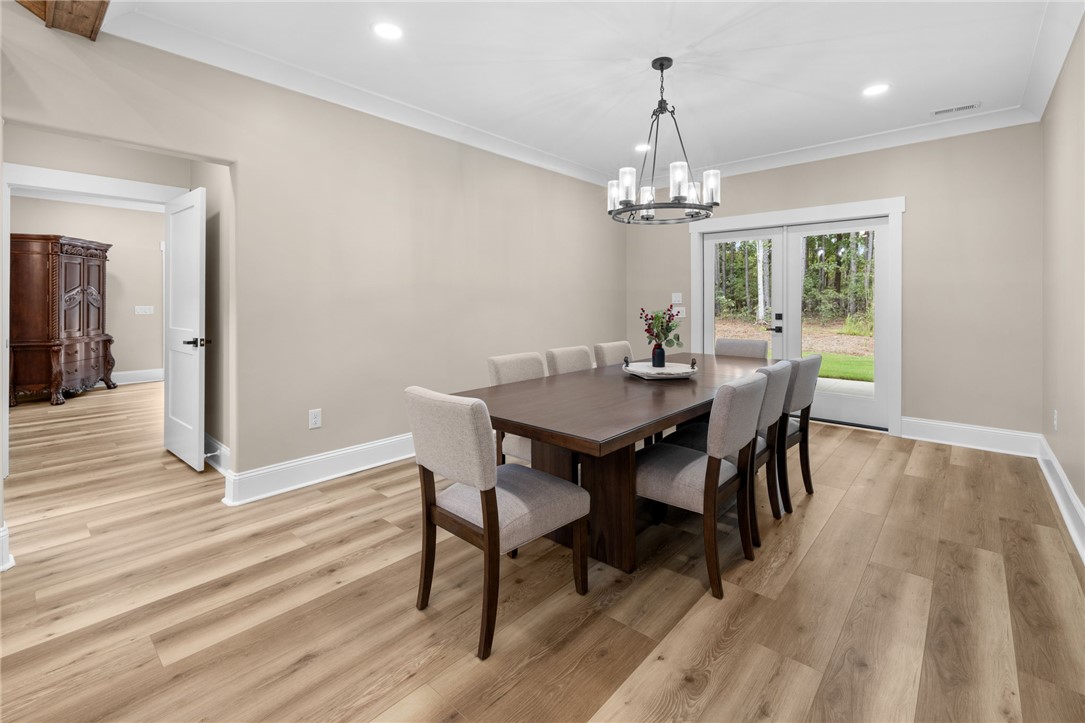 147 McAlister Road West Union, SC 29696 - Photo 13 of 50 Elegant wood floors pair perfectly with crown molding and double glass doors.