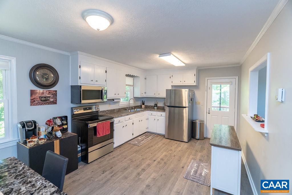 6920 Albevanna Spring Road Scottsville, VA 24590 - Photo 9 of 47 a kitchen with stainless steel appliances granite countertop a refrigerator stove top oven and sink