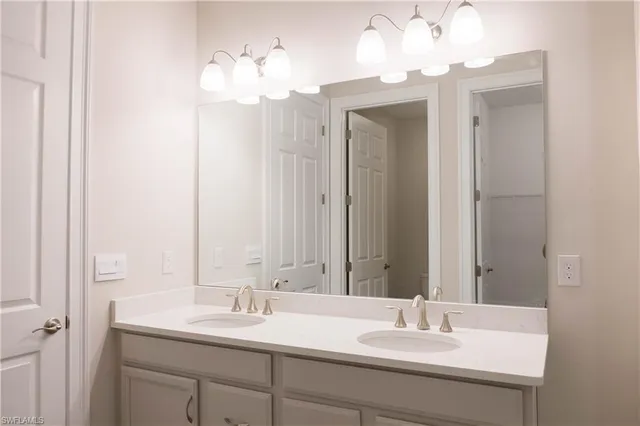 a bathroom with a sink double vanity and a mirror