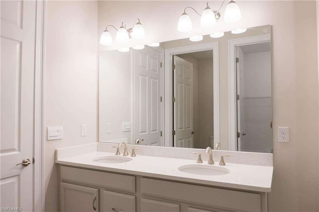 1050 Enbrook Loop Naples, FL 34114 - Photo 11 of 29 a bathroom with a sink double vanity and a mirror