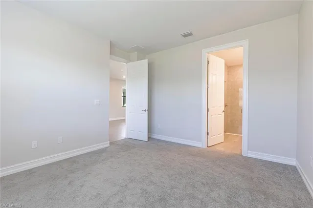 a view of an empty room and a window