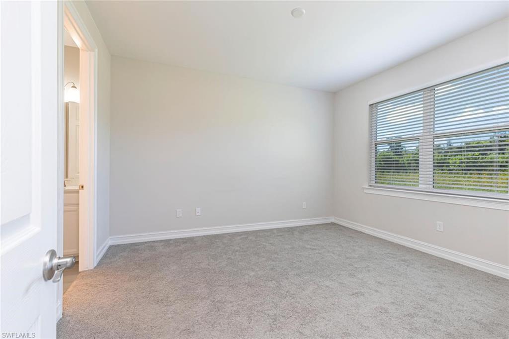 1050 Enbrook Loop Naples, FL 34114 - Photo 17 of 29 an empty room with windows