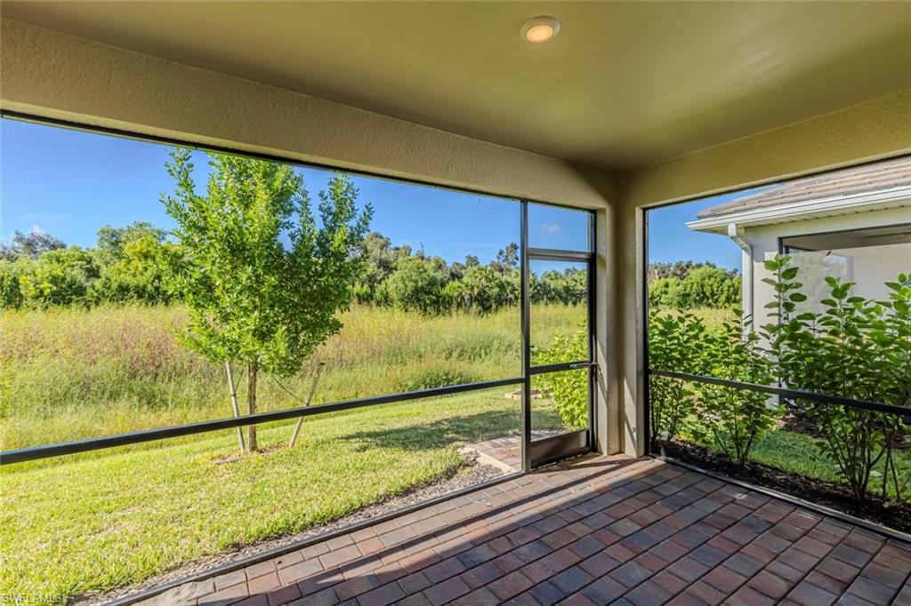 1050 Enbrook Loop Naples, FL 34114 - Photo 23 of 29 a view of a room with wooden floor and outdoor space