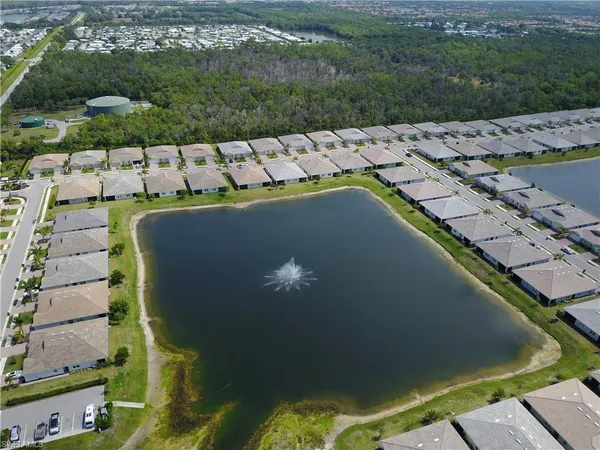 an aerial view of residential houses with outdoor space and swimming pool