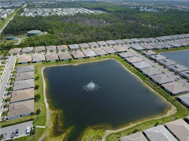 an aerial view of residential houses with outdoor space and swimming pool
