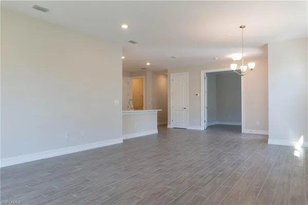 wooden floor in an empty room with a mirror