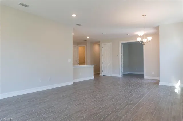 wooden floor in an empty room with a mirror