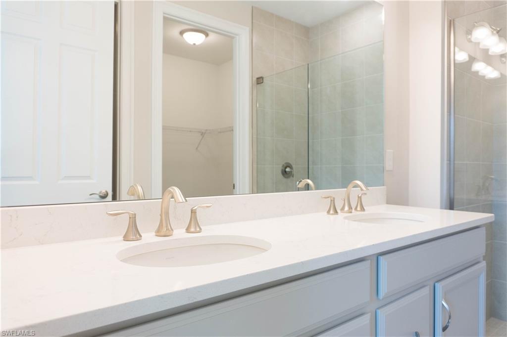 1050 Enbrook Loop Naples, FL 34114 - Photo 9 of 29 a bathroom with a sink and a mirror