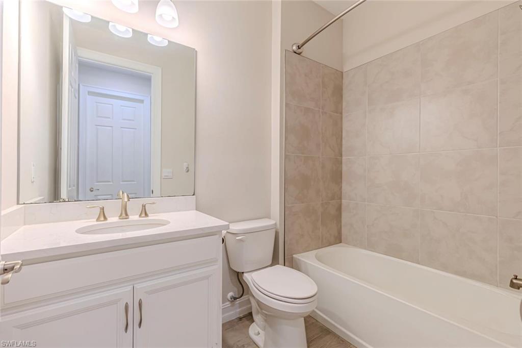 1050 Enbrook Loop Naples, FL 34114 - Photo 10 of 29 a bathroom with a sink toilet and shower