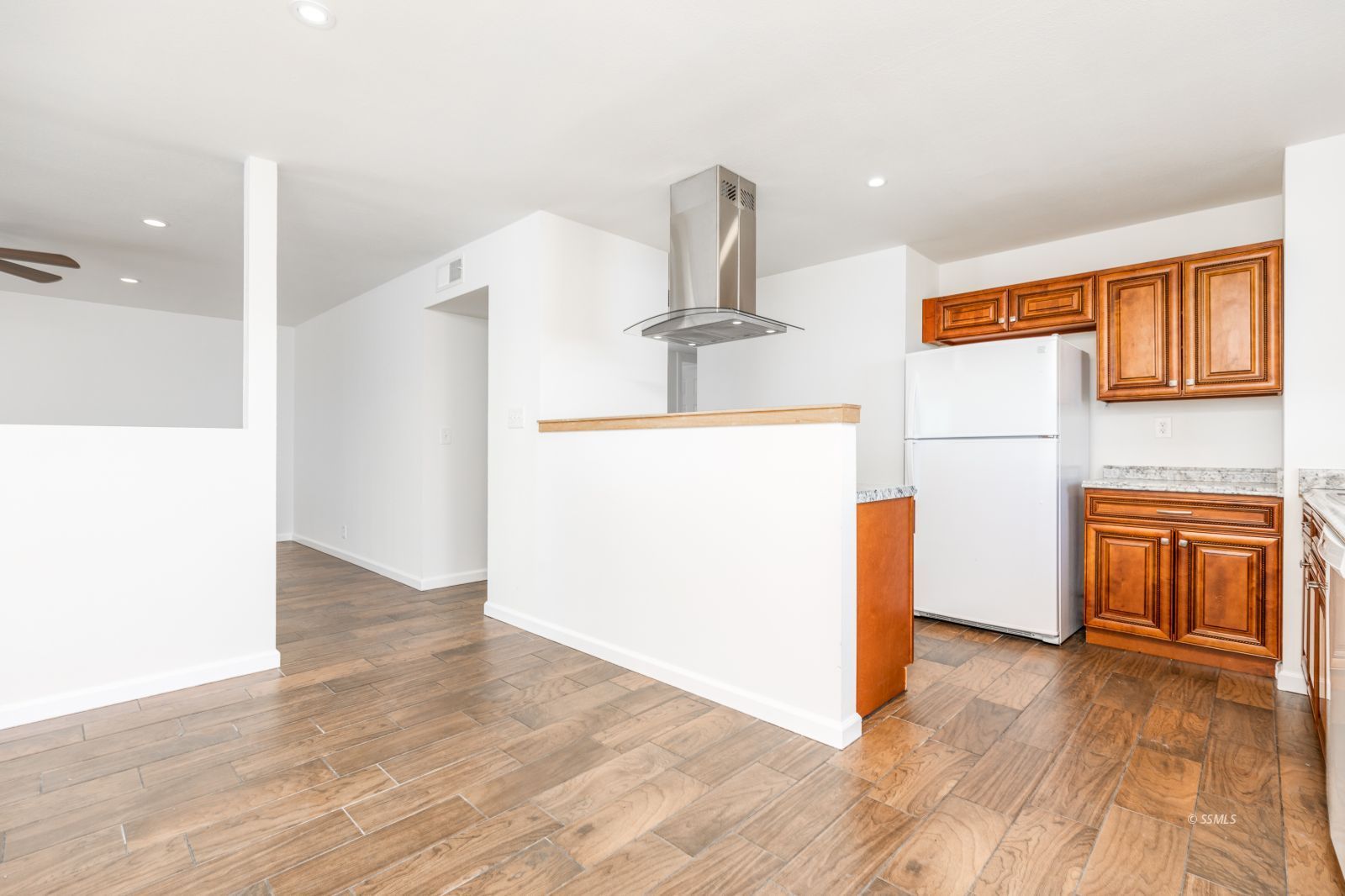 1425 Mayo Street Ridgecrest, CA 93555 - Photo 10 of 28 a view of a kitchen with a refrigerator and wooden floor