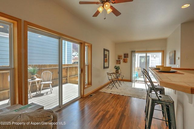 a view of a livingroom with furniture wooden floor and a window