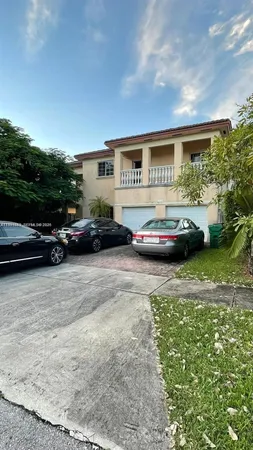 a view of a car parked in front of a house