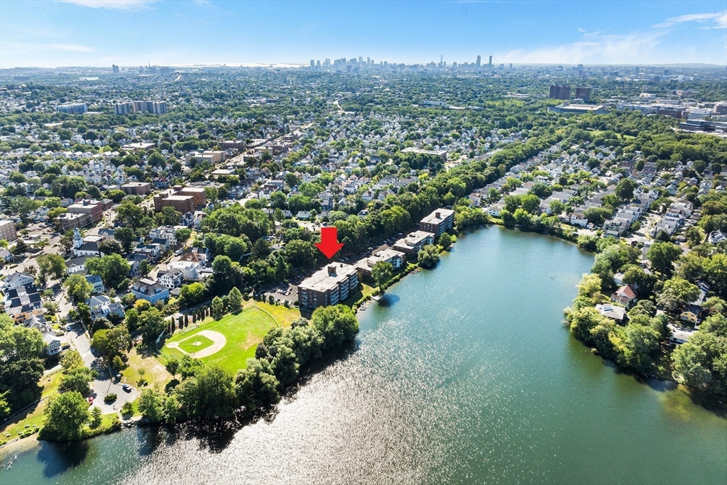 34 Hamilton Road, Unit 302 Arlington, MA 02474 - Photo 1 of 30 an aerial view of a city with lots of residential buildings lake and mountain view in back