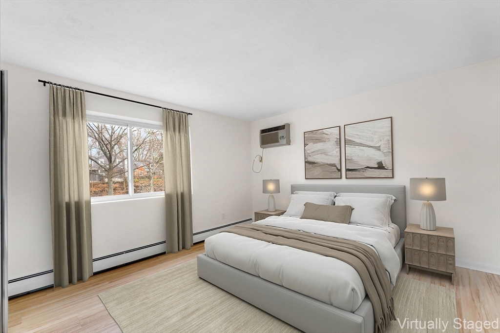 34 Hamilton Road, Unit 302 Arlington, MA 02474 - Photo 13 of 30 a bedroom with a large bed and a window