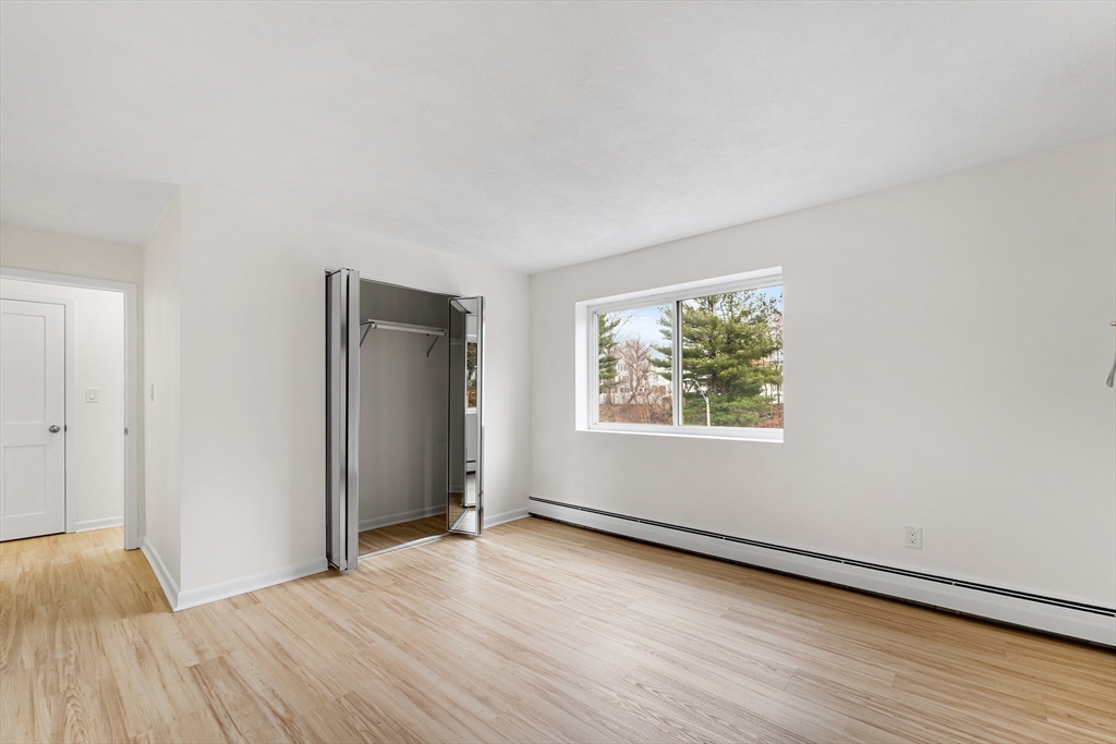34 Hamilton Road, Unit 302 Arlington, MA 02474 - Photo 14 of 30 a view of a big room with wooden floor and windows