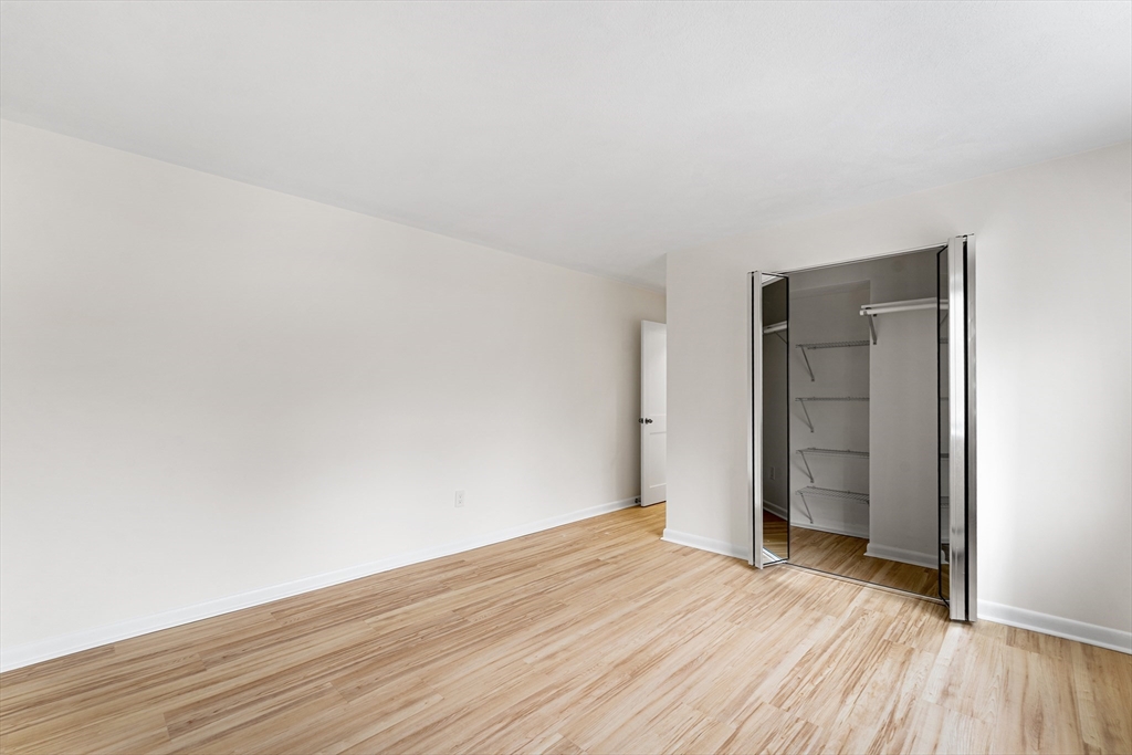 34 Hamilton Road, Unit 302 Arlington, MA 02474 - Photo 15 of 30 a view of an empty room and wooden floor