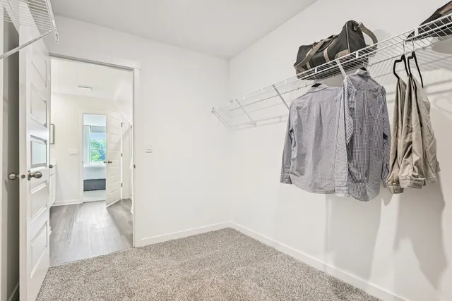 a view of a room with wooden floor and white walls