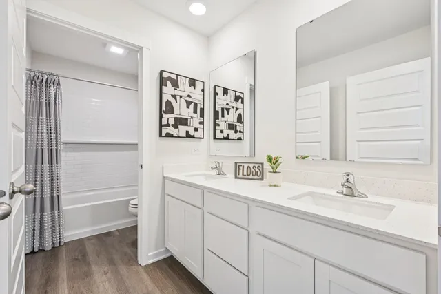 a white toilet sitting next to a bath tub