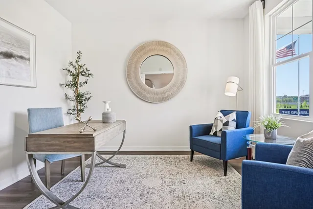 a living room with furniture and a mirror