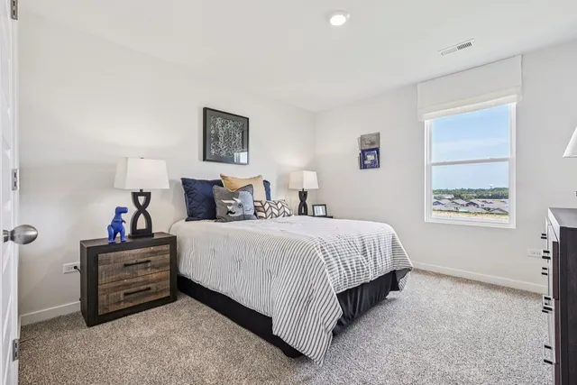 a bedroom with bed and window