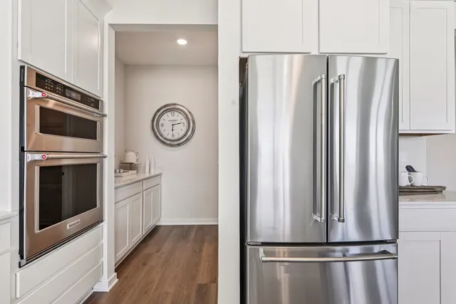 a view of kitchen with stainless steel appliances granite countertop a refrigerator and a stove top oven