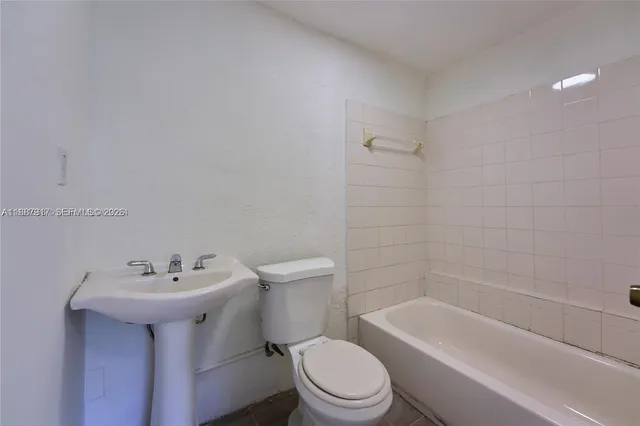 a bathroom with a sink toilet and bathtub