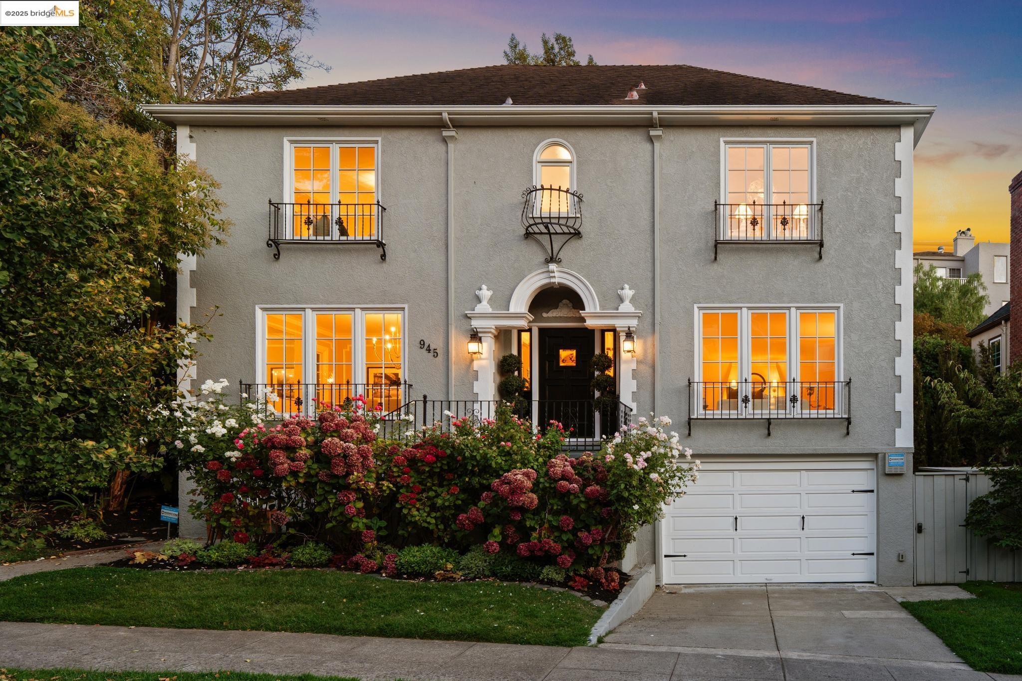 View of front of property featuring stucco siding, concrete driveway, and an attached garage