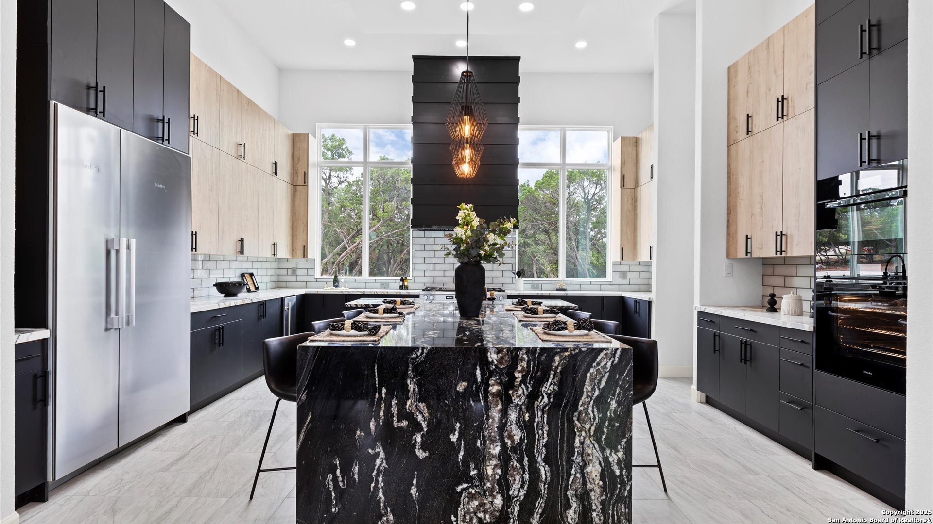 22327 Scenic Loop Road San Antonio, TX 78255 - Photo 14 of 59 a kitchen with stainless steel appliances granite countertop a refrigerator a sink dishwasher a stove and white countertops with wooden floor