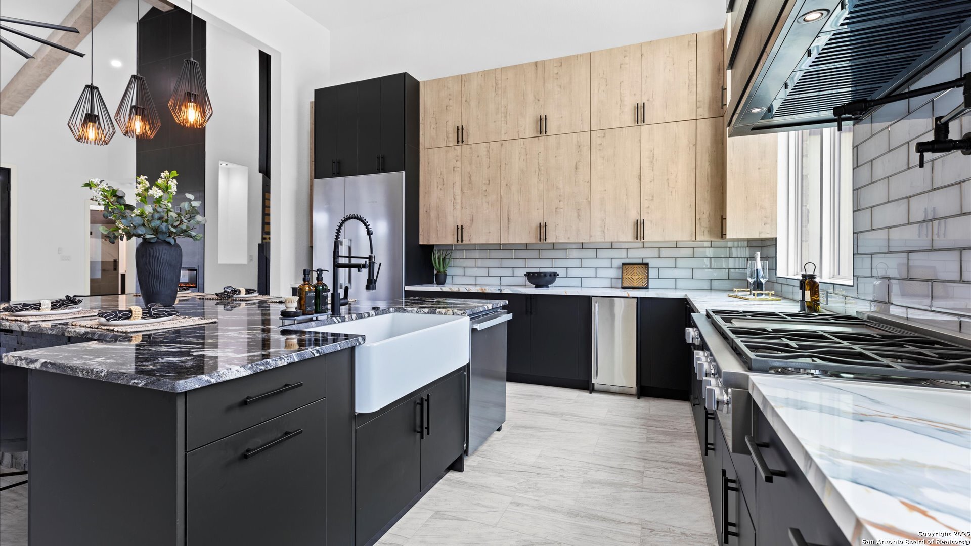 22327 Scenic Loop Road San Antonio, TX 78255 - Photo 17 of 59 a kitchen with kitchen island granite countertop a sink stove and cabinets