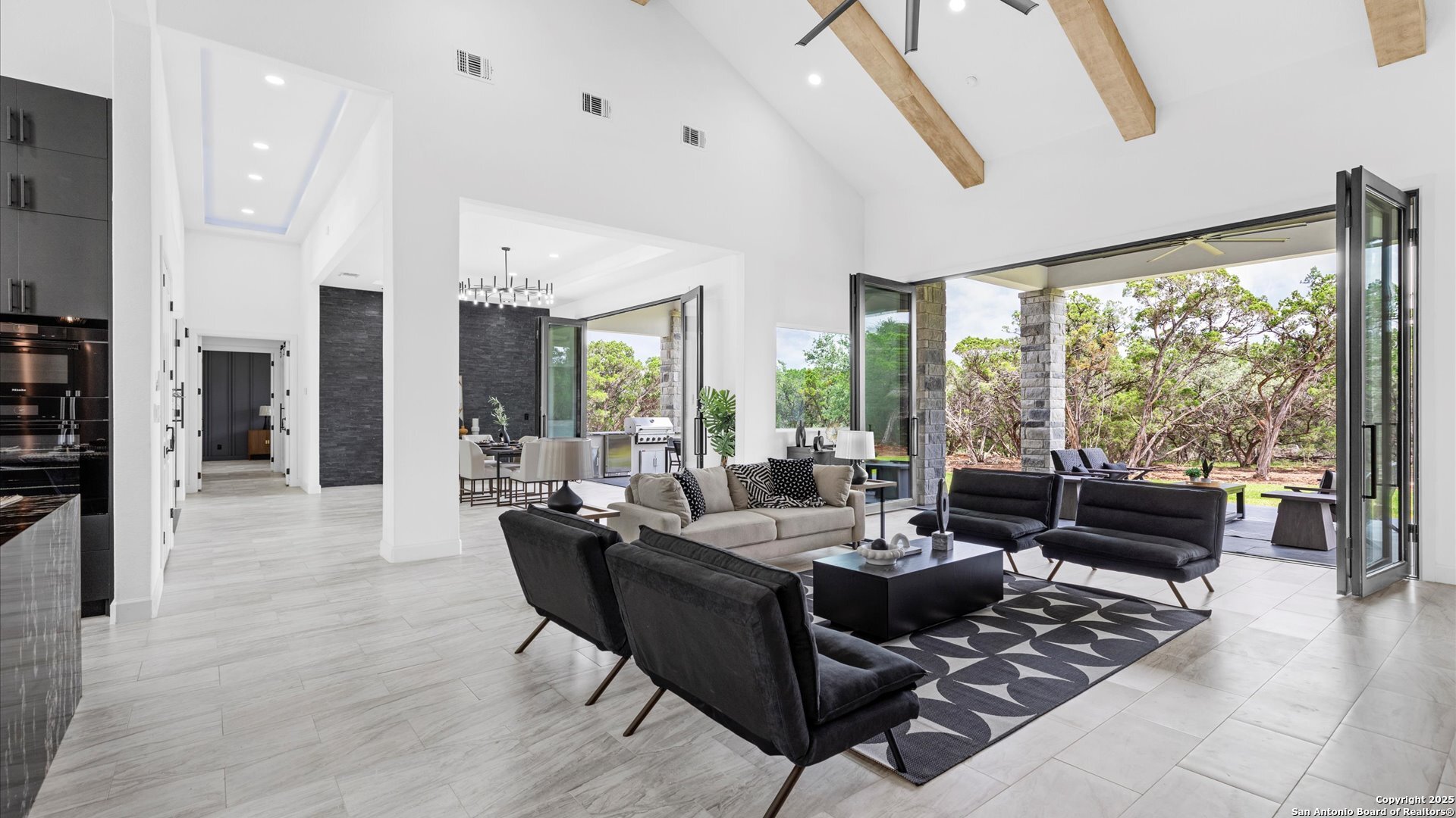 22327 Scenic Loop Road San Antonio, TX 78255 - Photo 20 of 59 a living room with furniture and a floor to ceiling window