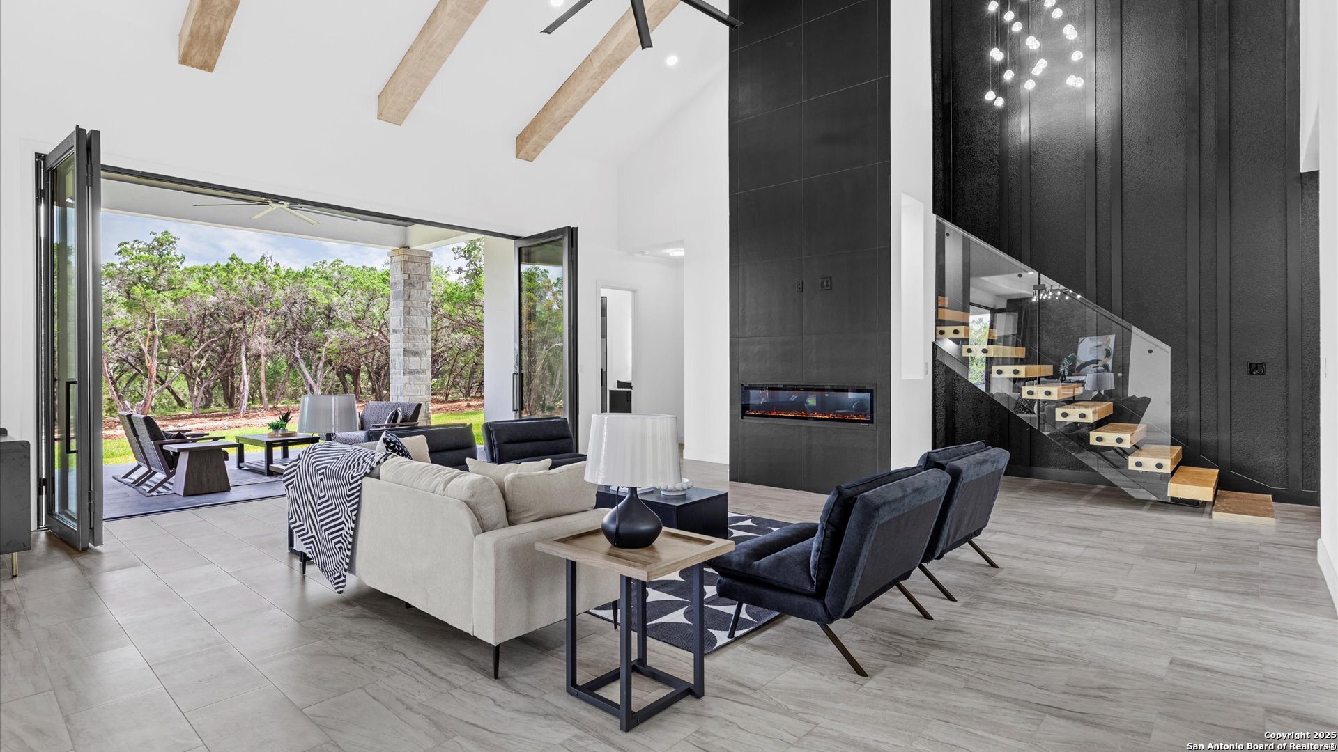 22327 Scenic Loop Road San Antonio, TX 78255 - Photo 2 of 59 a living room with furniture and a large window