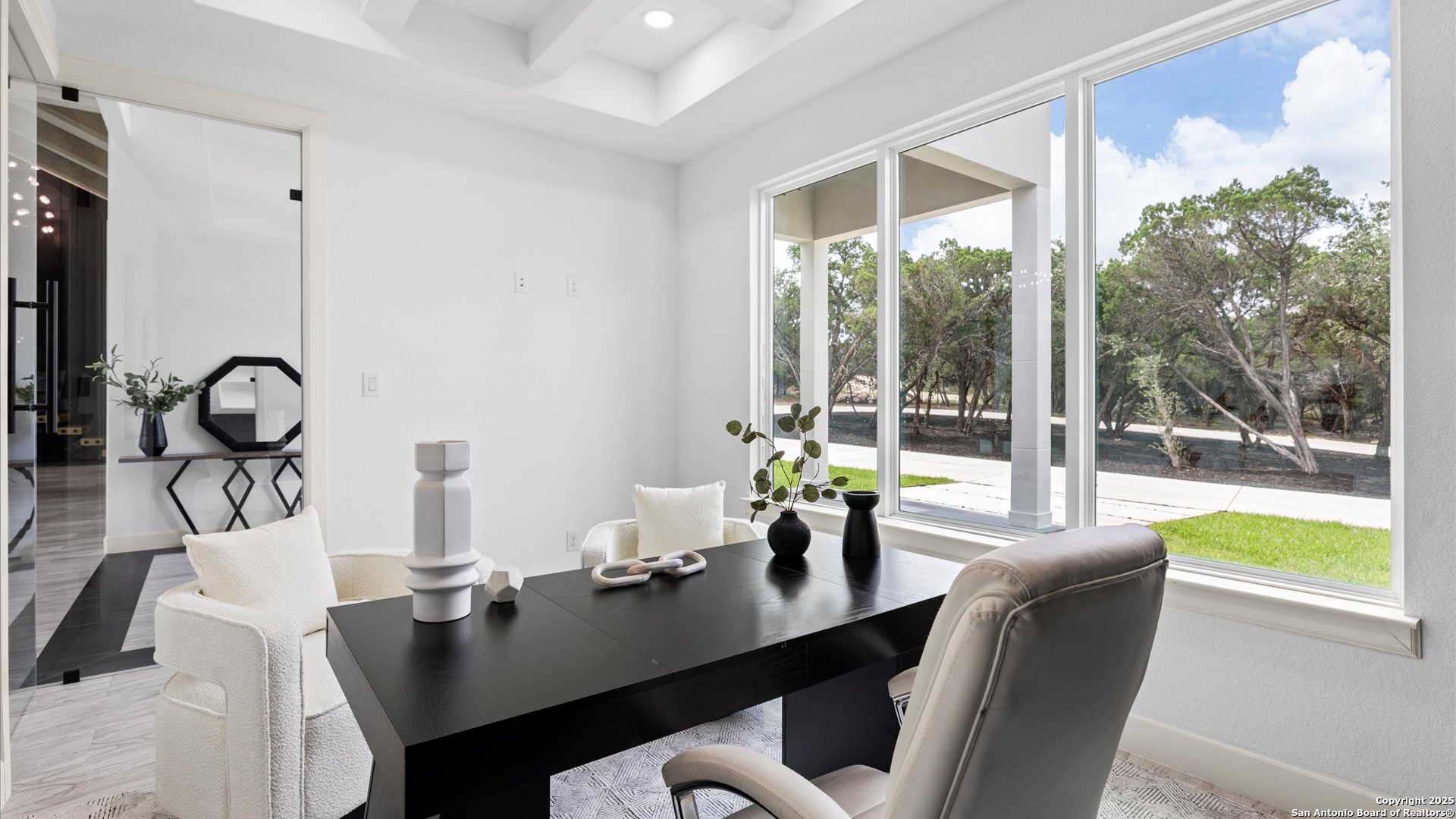 22327 Scenic Loop Road San Antonio, TX 78255 - Photo 34 of 59 a view of a dining room with furniture wooden floor and a chandelier