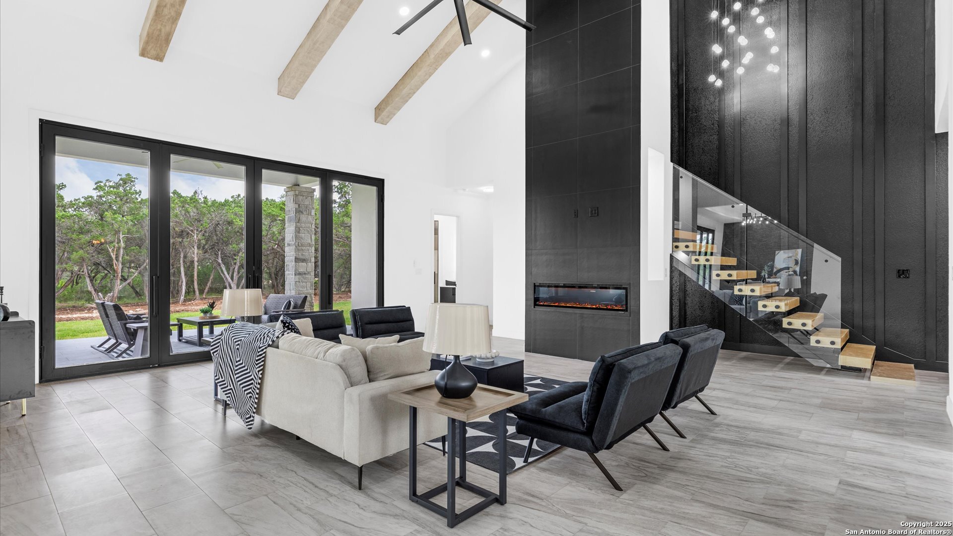 22327 Scenic Loop Road San Antonio, TX 78255 - Photo 42 of 59 a living room with furniture and a floor to ceiling window
